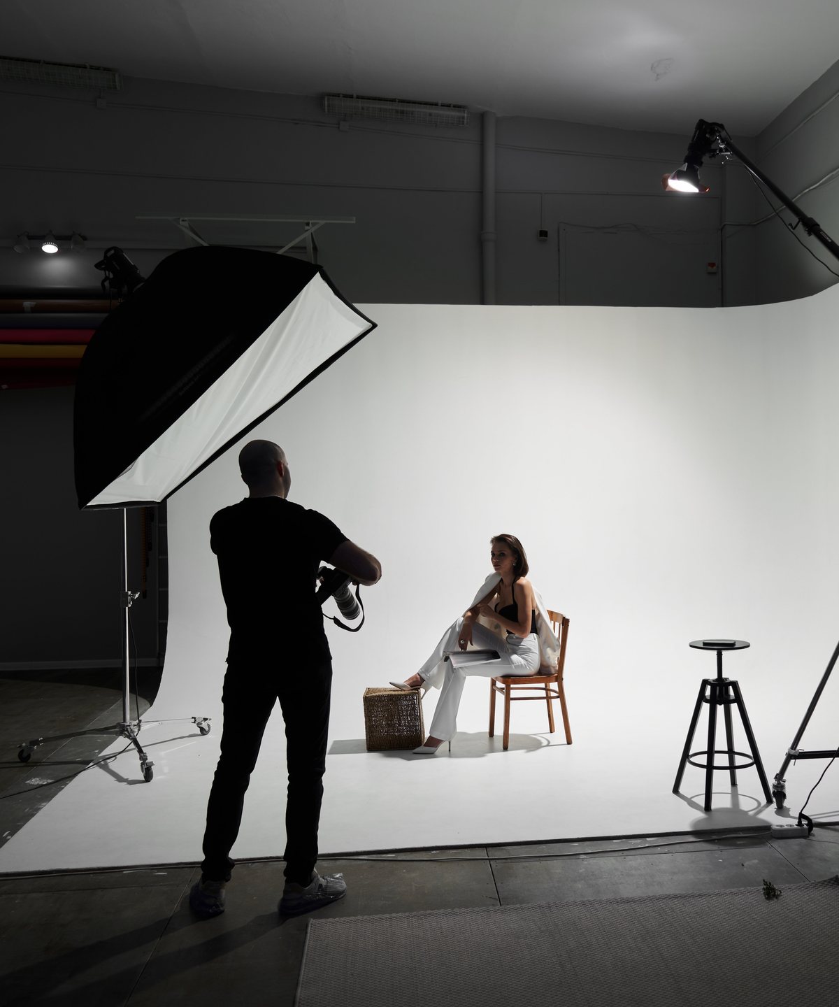 Photographer shooting a creator on a studio backdrop